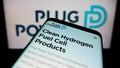 Mobile phone with webpage of American hydrogen fuel cell company Plug Power Inc. on screen in front of logo.