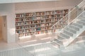 Stuttgart, Germany - Aug 1, 2020 - Bookshelf by stairs in the sunlight at Stadtbibliothek public library in the morning