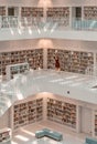 Stuttgart, Germany - Aug 1, 2020 - Woman with mask reads books at Stadtbibliothek library with sun light in the morning