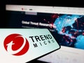 Cellphone with logo of cybersecurity company Trend Micro Inc. on screen in front of business website. Royalty Free Stock Photo