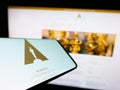 Mobile phone with logo of Academy of Motion Picture Arts and Sciences (AMPAS) on screen in front of website.