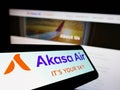 Mobile phone with logo of airline SNV Aviation Private Limited (Akasa Air) on screen in front of business website.