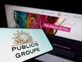 Mobile phone with logo of French advertising company Publicis Groupe SA on screen in front of business website. Royalty Free Stock Photo