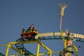 Amusement roller coaster  with people. Attractions at the Volksfest in Stuttgart, Germany. Royalty Free Stock Photo
