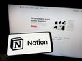 Person holding cellphone with logo of US software company Notion Labs Inc. on screen in front of business webpage. Royalty Free Stock Photo