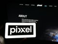 Person holding mobile phone with logo of Indian company Pixxel Space Technologies Inc. on screen in front of web page.