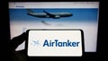 Person holding smartphone with logo of British company AirTanker Services Limited on screen in front of website. Royalty Free Stock Photo