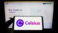 Person holding smartphone with logo of US crypto company Celsius Network LLC on screen in front of website. Royalty Free Stock Photo