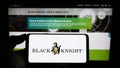 Person holding smartphone with logo of US financial services company Black Knight Inc. on screen in front of website.