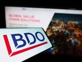 Smartphone with logo of accounting network BDO Global on screen in front of business website. Royalty Free Stock Photo