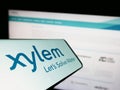 Smartphone with logo of American water technology company Xylem Inc. on screen in front of website.