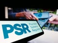 Smartphone with logo of British Payment Systems Regulator (PSR) on screen in front of business website. Royalty Free Stock Photo