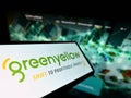 Smartphone with logo of French energy company GreenYellow SAS on screen in front of business website.