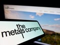 Smartphone with logo of mining company TMC The Metals Company Inc. on screen in front of business website.