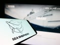 Smartphone with logo of Sea Shepherd Conservation Society (SSCS) on screen in front of website.