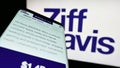 Smartphone with website of US digital media company Ziff Davis Inc. on screen in front of business logo.
