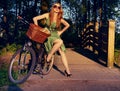 Style, bridge and bicycle with woman in park for cycling, trend and nature. Happy, smile and fashion with vintage female Royalty Free Stock Photo