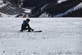 Style carving. A male skier training on competition in downhill. Carve position. Black and blue jacket. Chopok, Low Tatras,