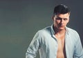 Style and fashion concept. Handsome man with stylish hair. Sexy macho in open shirt show fit chest. Guy with serious Royalty Free Stock Photo
