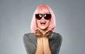 Happy woman in pink wig holding something on palms Royalty Free Stock Photo