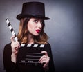 Style redhead girl in top hat with movie clapperboard Royalty Free Stock Photo