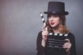 Style redhead girl in top hat with movie clapperboard Royalty Free Stock Photo