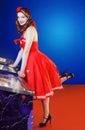 Style pinup girl in red dress, play pinball. Royalty Free Stock Photo