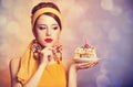 Style redhead girl with cake. Royalty Free Stock Photo