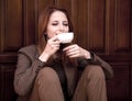 Style redhead girl drinking coffee Royalty Free Stock Photo