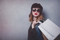 Style redhead girl in hat with shopping bags and sunglasses Royalty Free Stock Photo