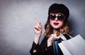 Style redhead girl in hat with shopping bags and sunglasses Royalty Free Stock Photo