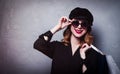 Style redhead girl in hat with shopping bags and sunglasses Royalty Free Stock Photo