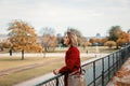 Girl in red coat and bag looking at park Royalty Free Stock Photo