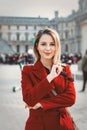 Redhead girl in red coat and bag on parisian street Royalty Free Stock Photo