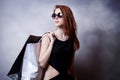 Style redhead girl with shopping bags