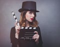 Style redhead girl in top hat with movie clapperboard Royalty Free Stock Photo