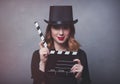 Style redhead girl in top hat with movie clapperboard Royalty Free Stock Photo