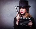 Style redhead girl in top hat with movie clapperboard Royalty Free Stock Photo