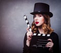 Style redhead girl in top hat with movie clapperboard Royalty Free Stock Photo