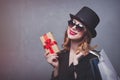 Style redhead girl in top hat with shopping bags and gift box Royalty Free Stock Photo