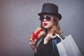 Style redhead girl in top hat with shopping bags and gift box Royalty Free Stock Photo