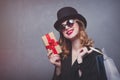 Style redhead girl in top hat with shopping bags and gift box Royalty Free Stock Photo