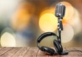 Retro style microphone and headphones on wooben Royalty Free Stock Photo