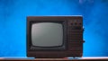 Style retro Tv set with switchers. Old fashioned TV against a smoky studio background with blue neon lights. Slow motion