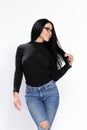 Attractive european girl with black hair and glasses posing in studio on  background. Style, trends, fashion concept. Royalty Free Stock Photo