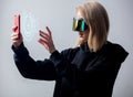 woman in concept VR glasses using cloud storage on mobile phone on white background