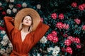 Style woman near rhododendron flowers in a grarden Royalty Free Stock Photo