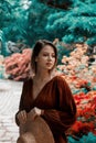 Style woman near rhododendron flowers in a grarden Royalty Free Stock Photo