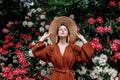 Style woman near rhododendron flowers in a grarden Royalty Free Stock Photo