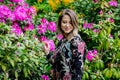 Style woman near rhododendron flowers in a grarden Royalty Free Stock Photo